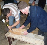 Douglas gouging out the hull.